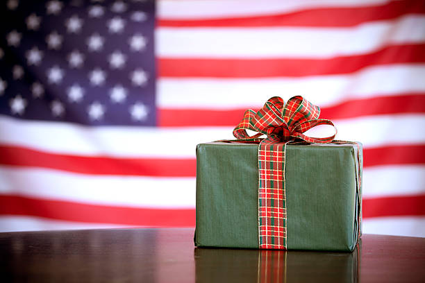 green gift box with red ribbon on an American flag _ patriotic gifts for him