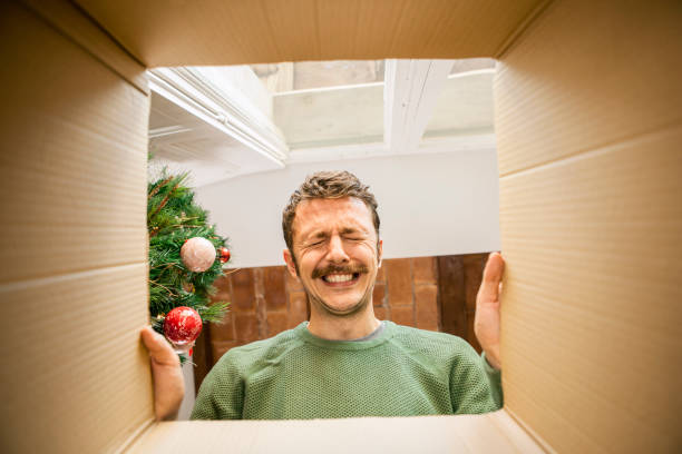 Man opening funny Christmas present _ funny christmas gifts for dad