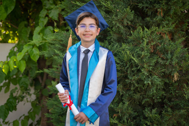 Teenage boy wearing cap and gown graduating from 5th grade_5th grade graduation gift ideas for boy