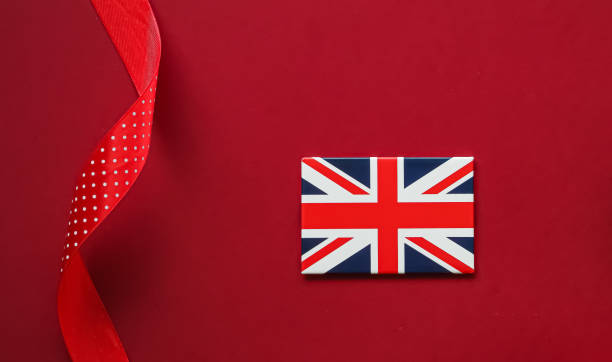 Union Jack flag of Great Britain on red background, Queen's Platinum Jubilee and holiday celebration concept - british gifts for foreign friends