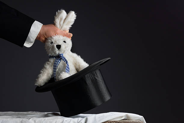 Man in suit pulling a rabbit out of the topper hat on a theater performance - gifts for a theater major