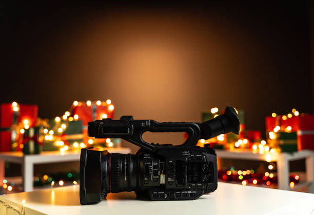 A video camera in front of a christmas tree during the gifing season - gifts for a videographer