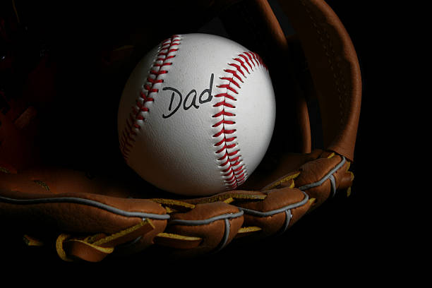A picture of a glove holding a baseball with Dad written on the ball - baseball Father's Day gifts
