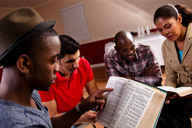 Young adults meeting together in a Bible study. They are in Church fellowship hall. Multi-ethnic group. Latin, African descent people. - bulk christian Father's Day gifts