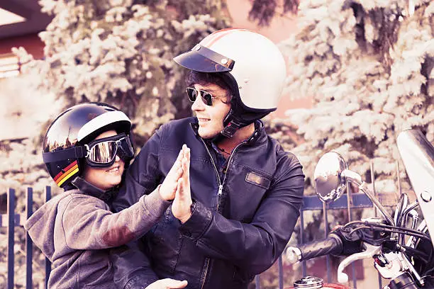 father and son motorcyclists high five - Harleys Davidson Father's Day gifts