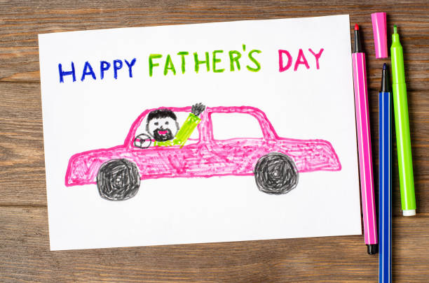 A child's drawing on a wooden table. Dad is driving a car. A postcard for the Father's Day holiday. -Father's Day gifts for car guys