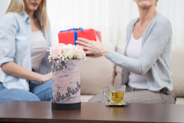 Flowers are on the table because you are the day for gifts. Mother's Day gifts for daughter-in-law
