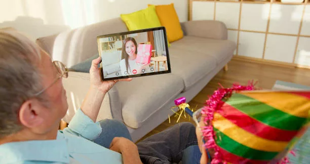 asian grandfather celebrates for grandson birthday and mother gives present from video call with them by digital tablet at home -gifts for korean dads