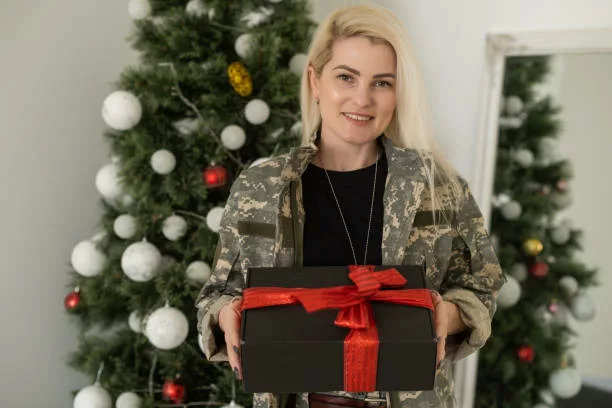 A female soldier, military woman standing in front Christmas tree. - gifts for marine girlfriend